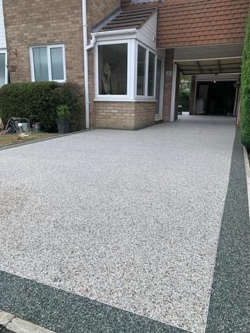 Gravel driveway and decorative stone landscaping by JP Driveways & Landscaping: project 3